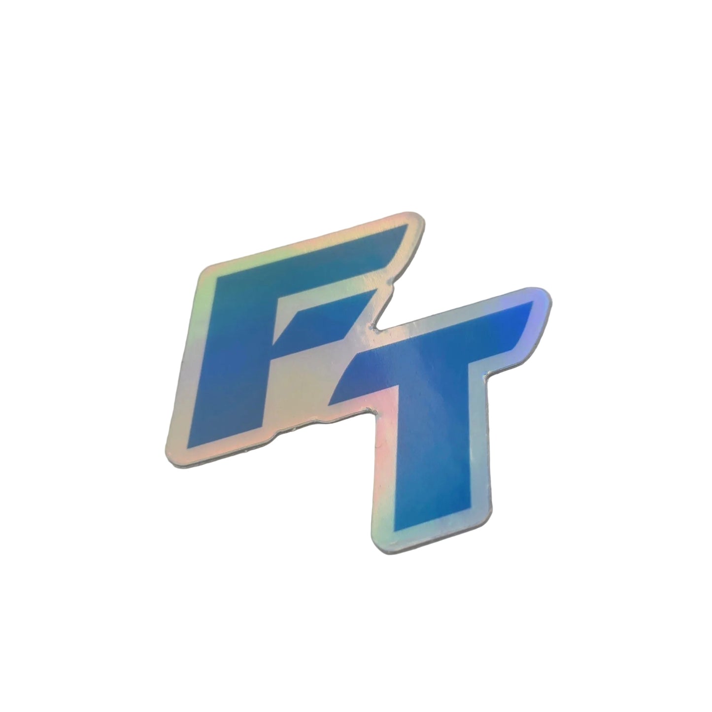 A stylized holographic 'FT' logo decal in blue with iridescent rainbow reflections, placed on a light gray textured surface.