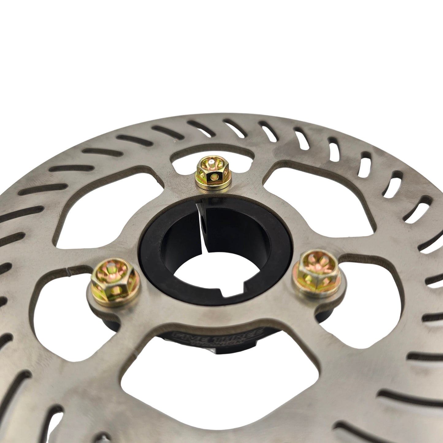 Close-up of a metallic brake disc with gold screws on a light gray background